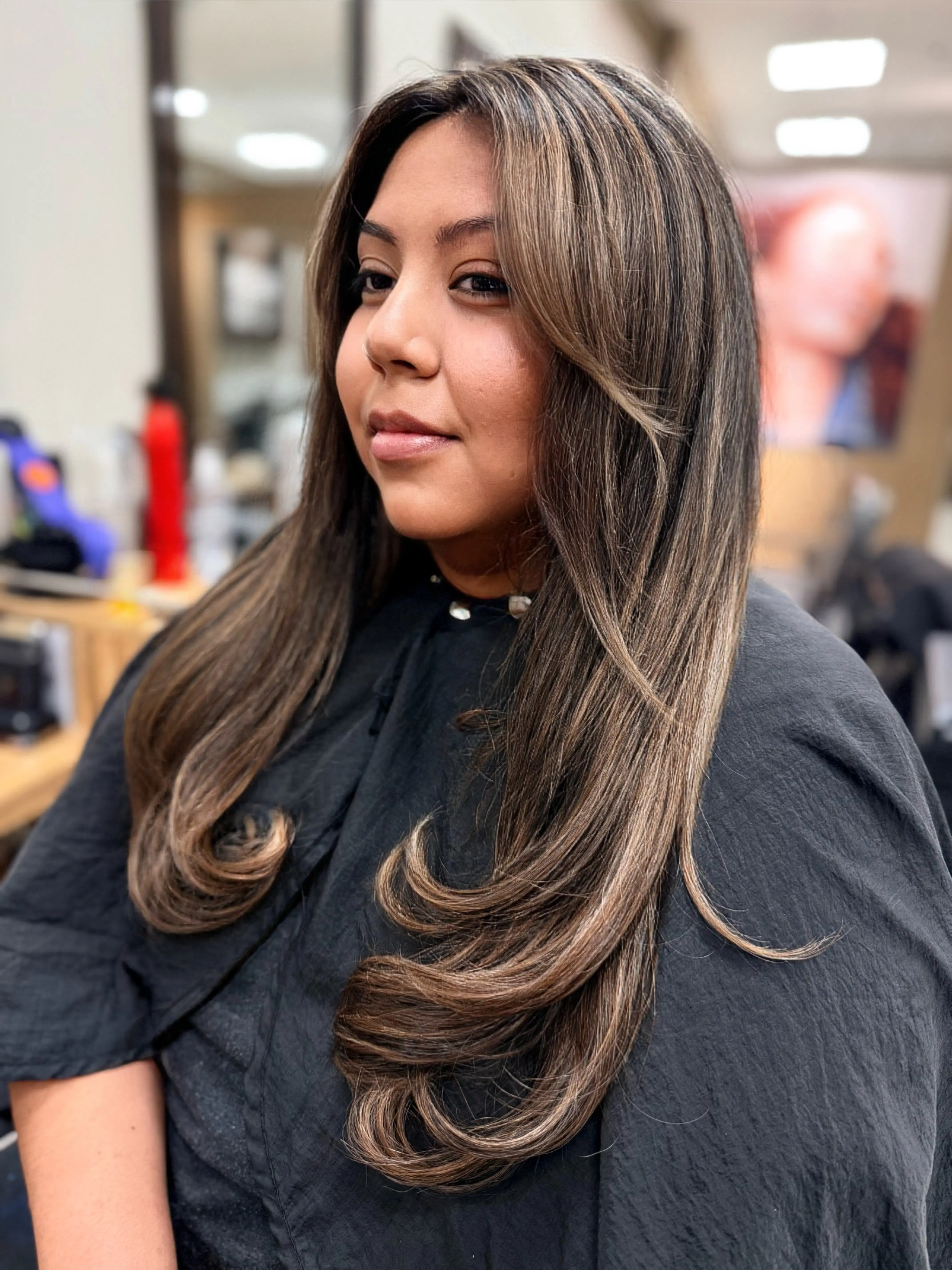Caramel balayage on long brunette hair, in profile