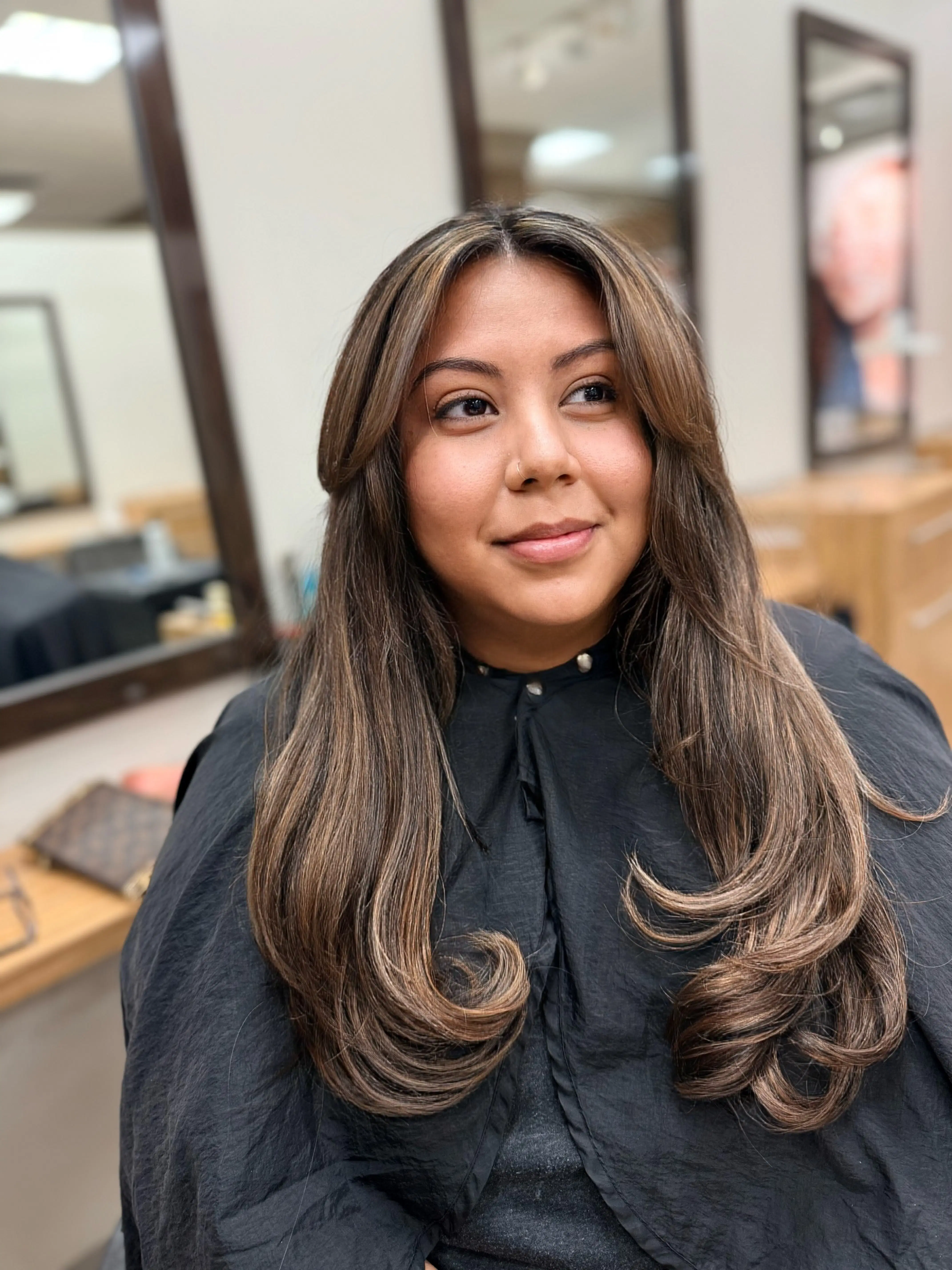 Long caramel balayage with face-framing layers and loose curls