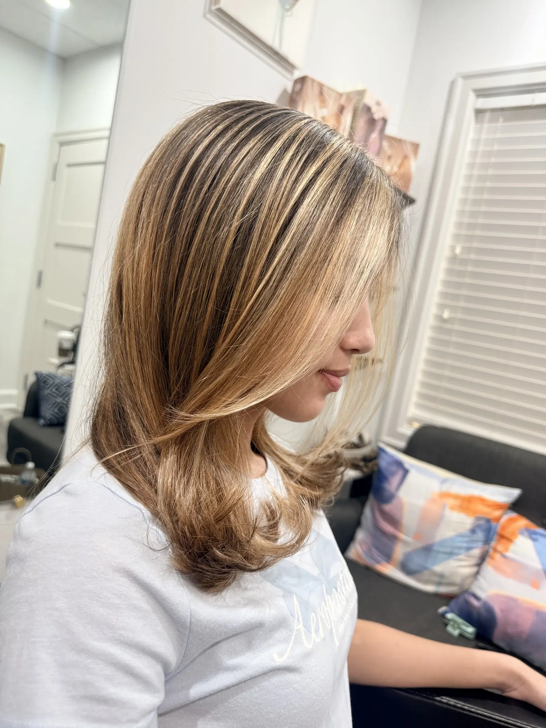 Golden blonde ribbons in profile, from the face-framing pieces to the ends