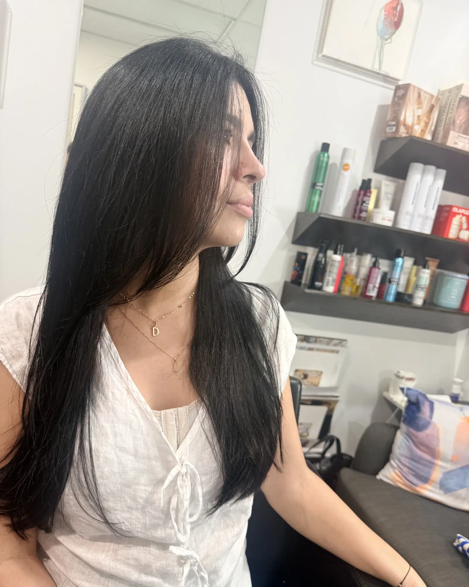 Glossy jet-black hair in profile after a color gloss and strengthening treatment by Rudy Perez Machado