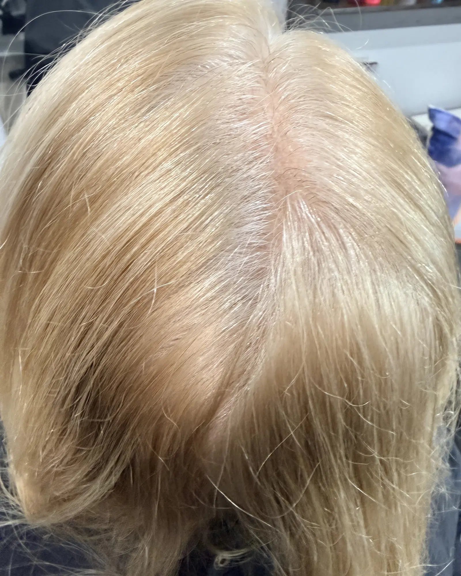 Grey and dark regrowth on blonde hair before a touch-up