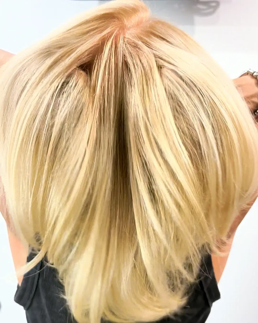 Bright blonde lob from the back after a root touch-up and gloss by Rudy Perez Machado