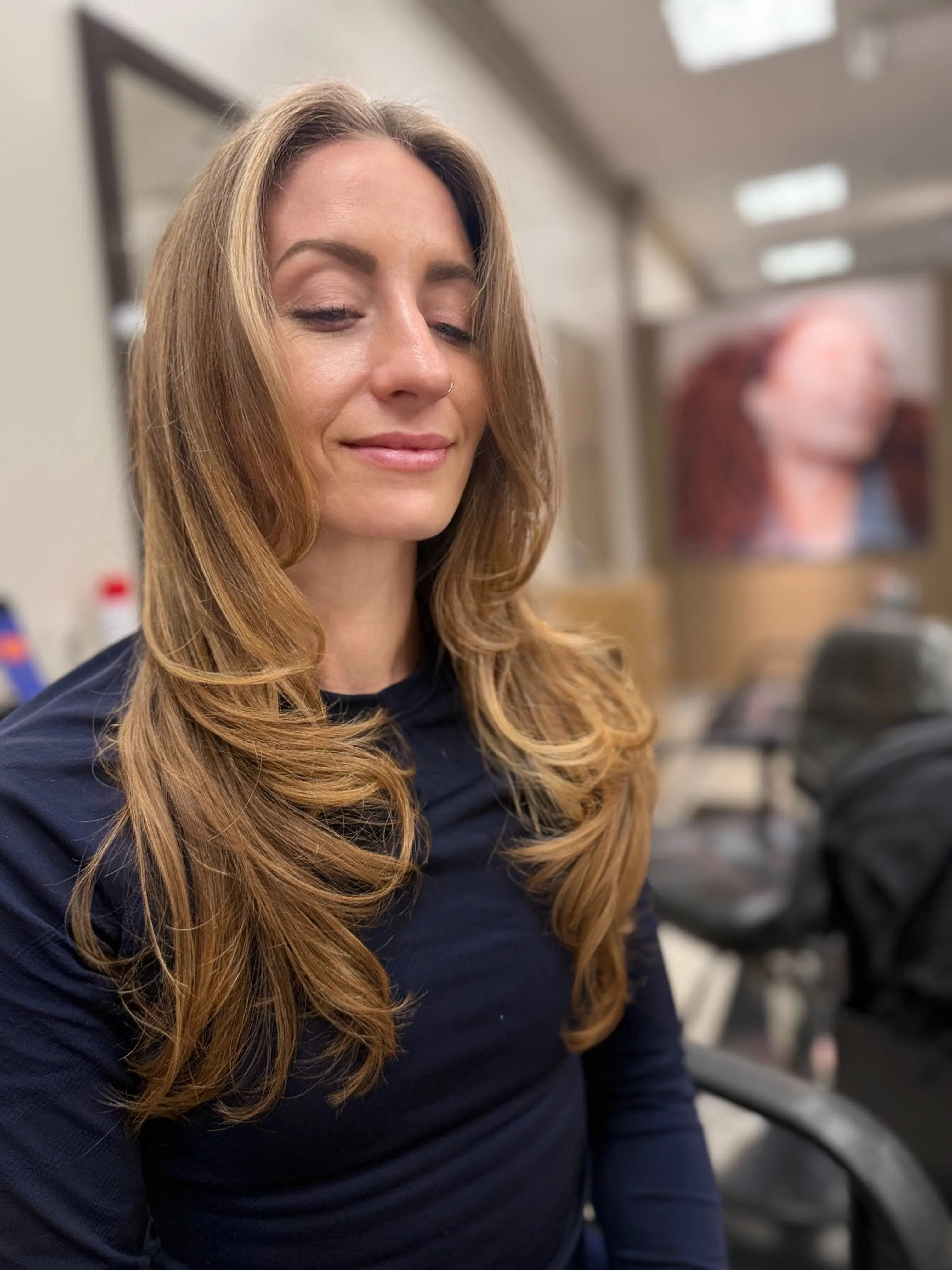 Warm honey balayage on long layered hair