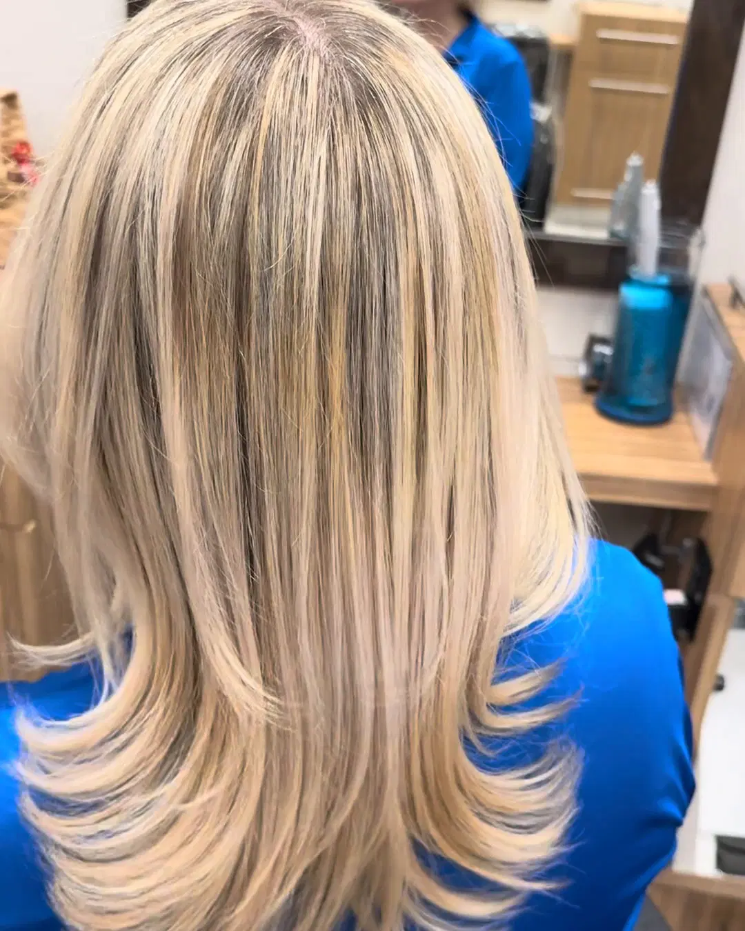 Bright, dimensional blonde highlights on long layered hair